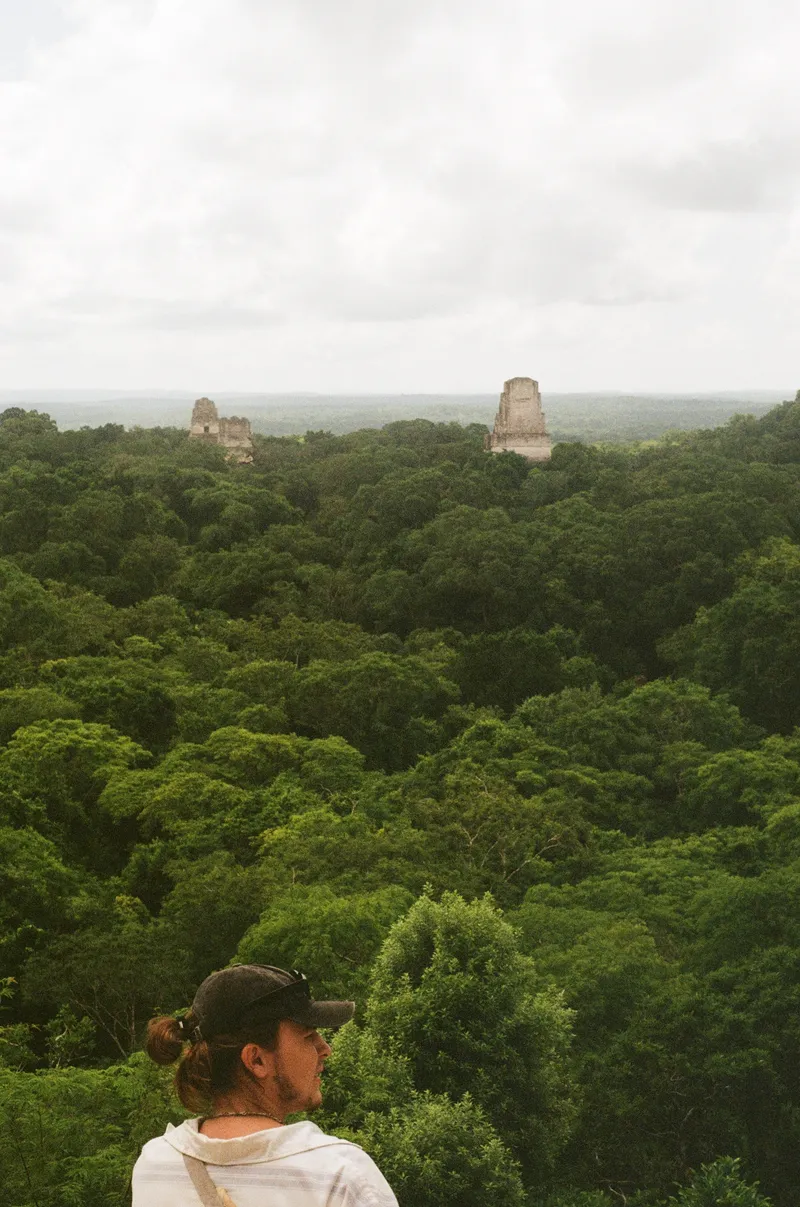 Max with Tikal ruins poking through the jungle in the background