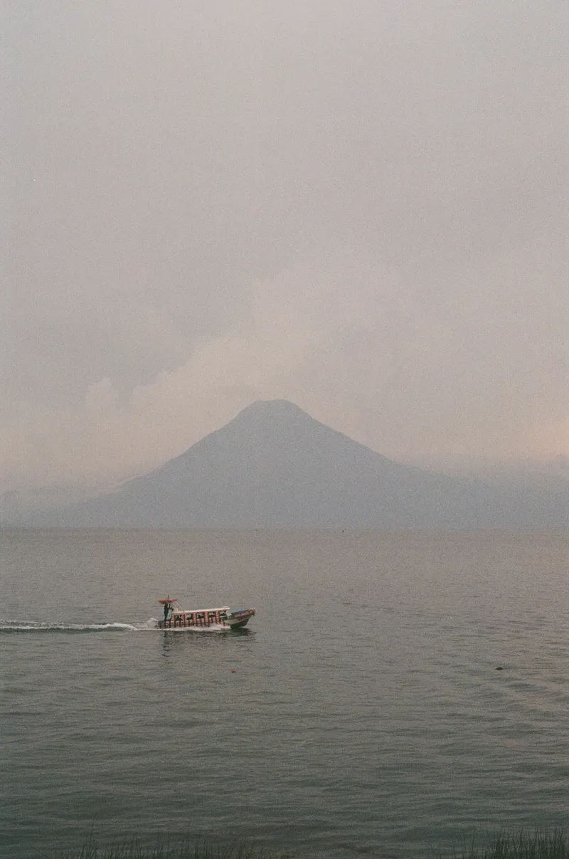 Boat in front of volcano in Lake Atitlan, Guatemala