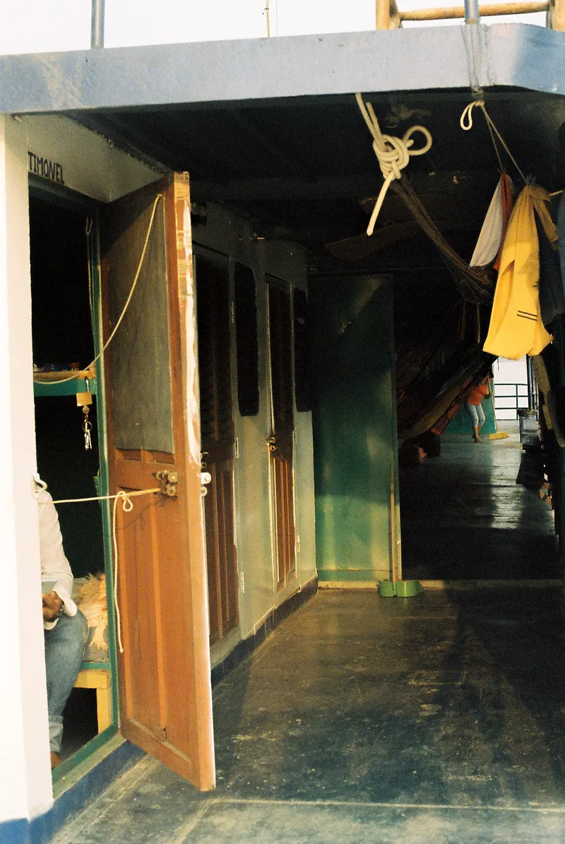 Cabin doorways and hammocks on the deck of an Amazon river boat