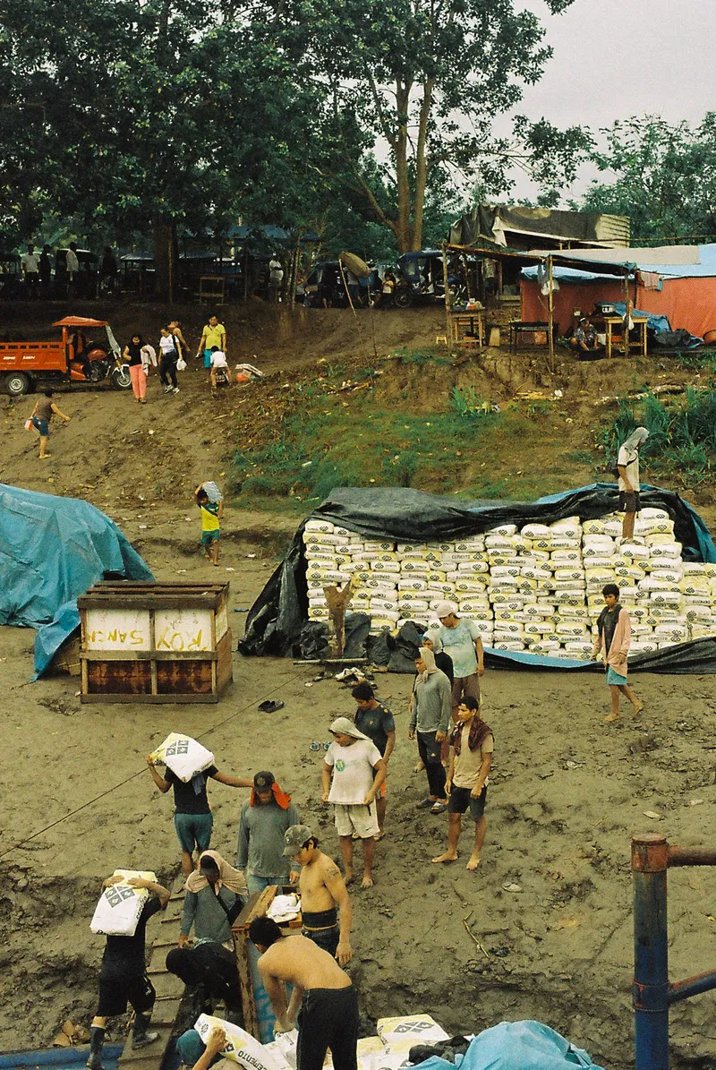Sacks of cargo stacked on the Amazon riverbank