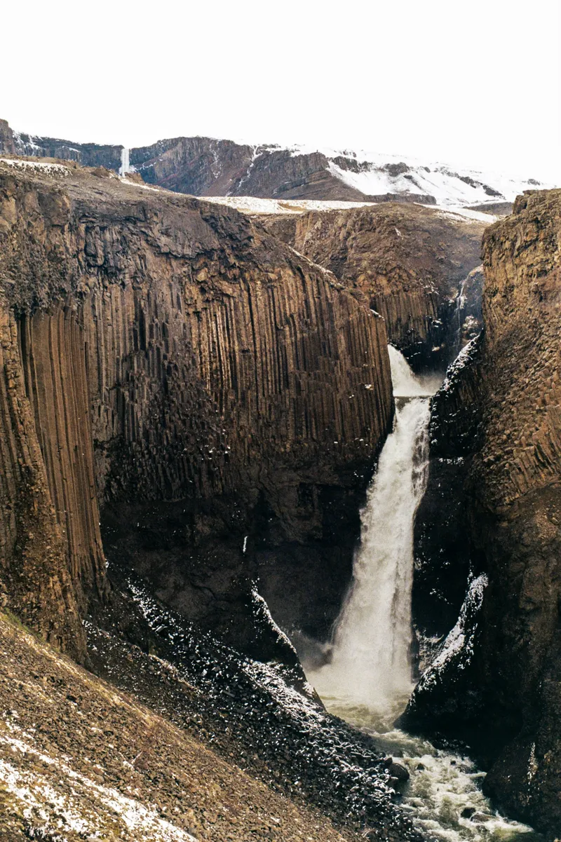Waterfall framed by basalt columns in east Iceland