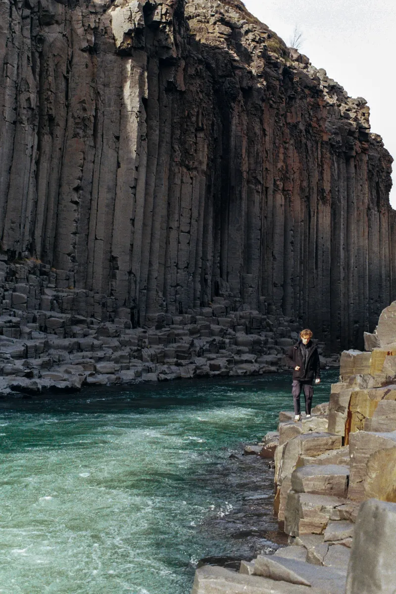 Standing among the basalt columns of Studlagil canyon, Iceland