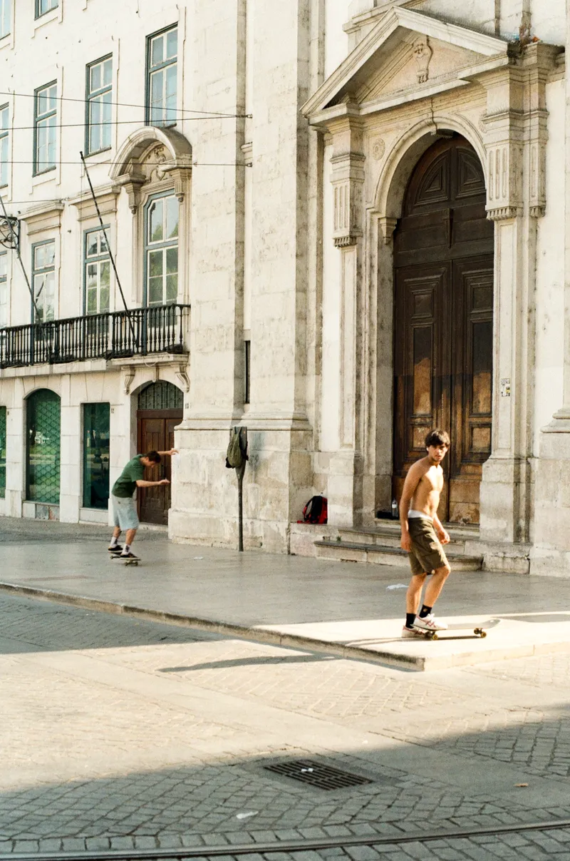 Skateboarders outside a church in Lisbon
