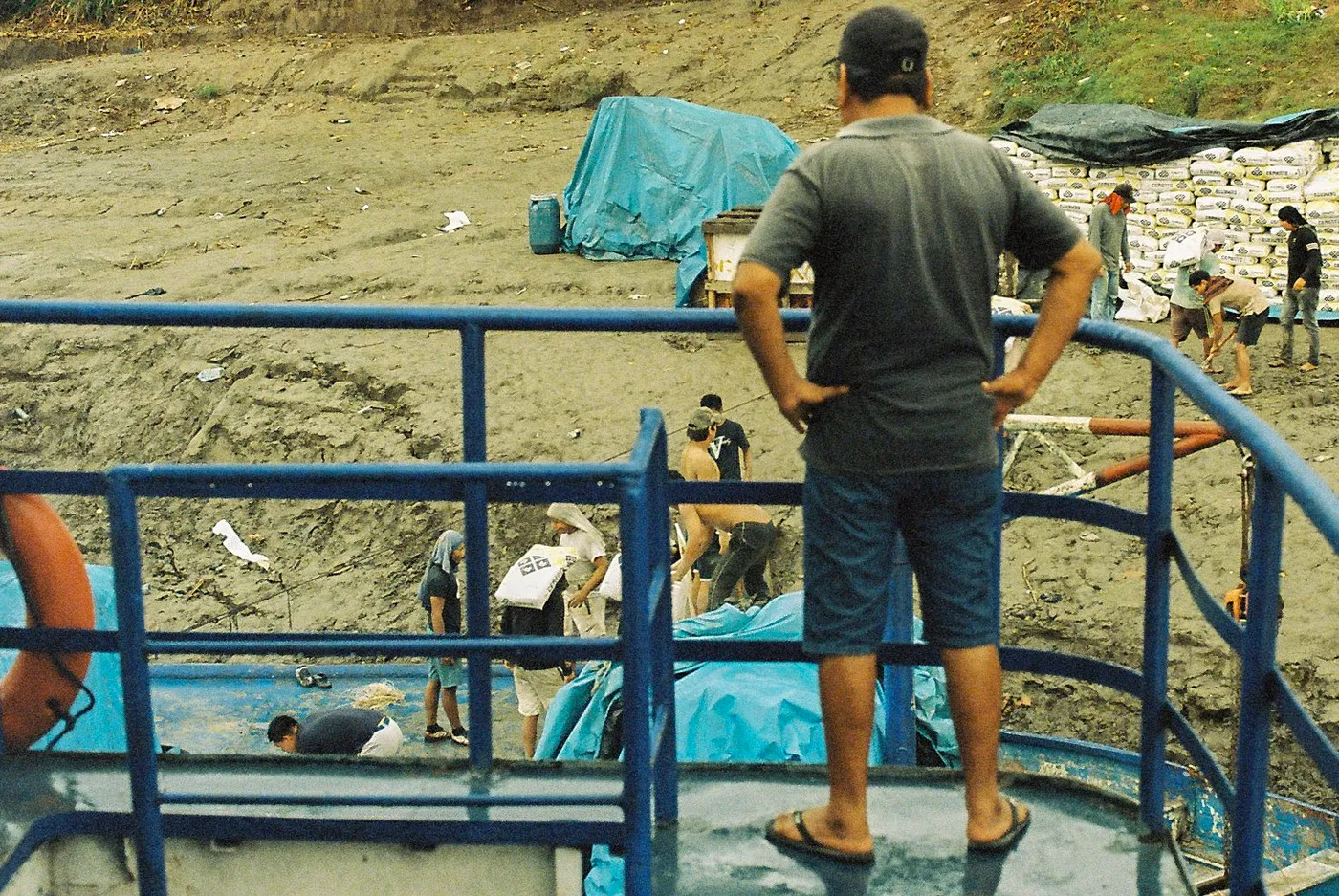 Watching cargo being loaded from the rail of an Amazon slow boat