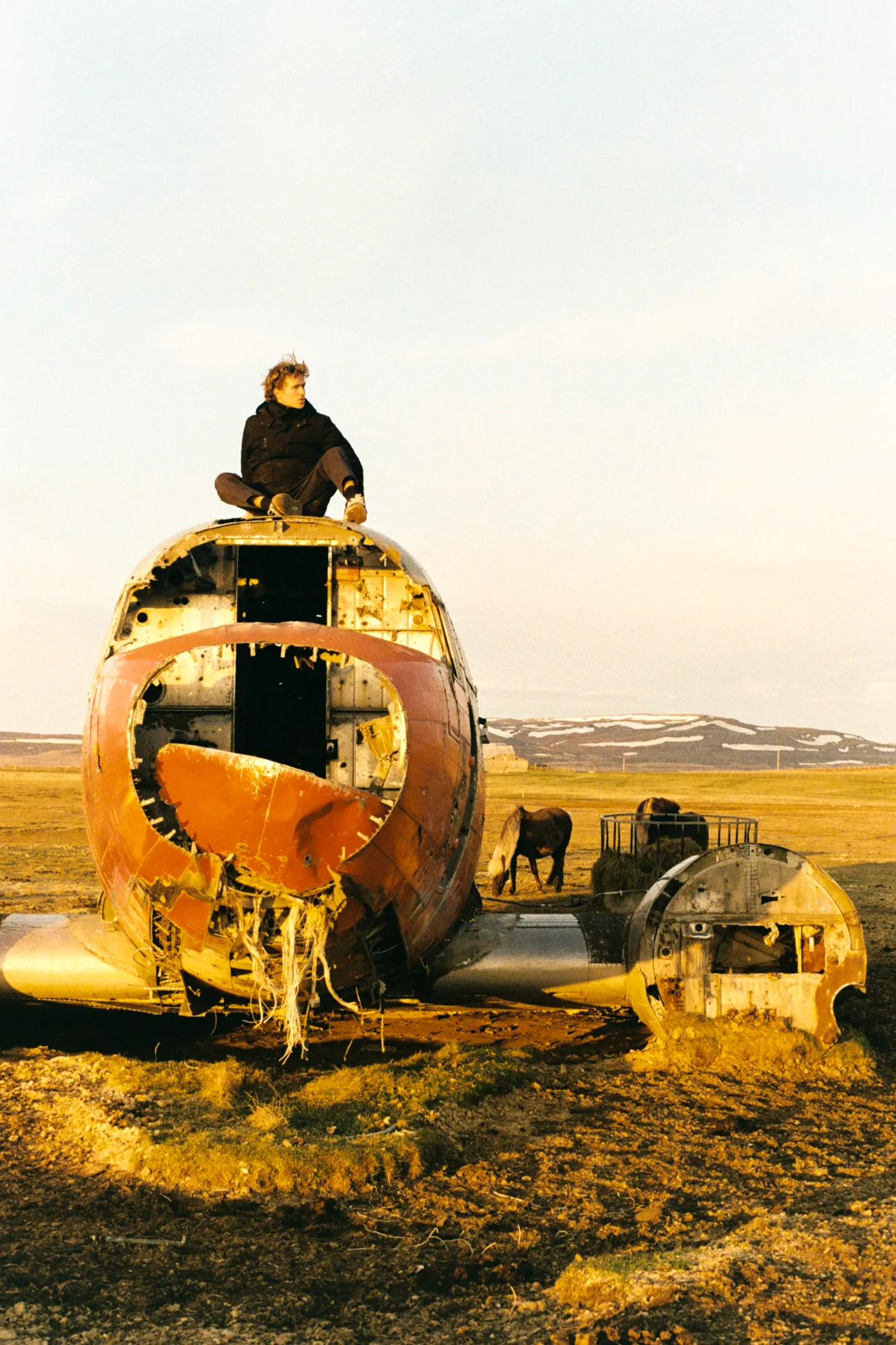 Sitting on the wreck of a crashed plane near Thorshofn, Iceland
